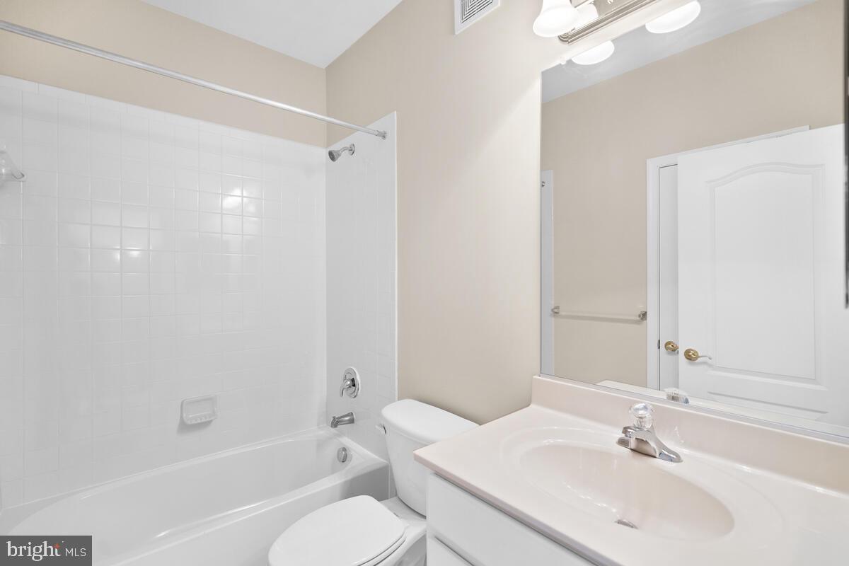 13626 Dover Cliffs Place Germantown, MD 20874 - Photo 27 of 32 a bathroom with a bathtub shower sink vanity mirror and toilet