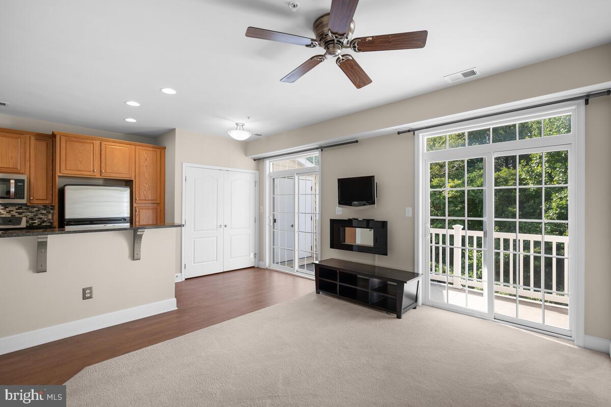 13626 Dover Cliffs Place Germantown, MD 20874 - Photo 6 of 32 a living room with furniture and a flat screen tv