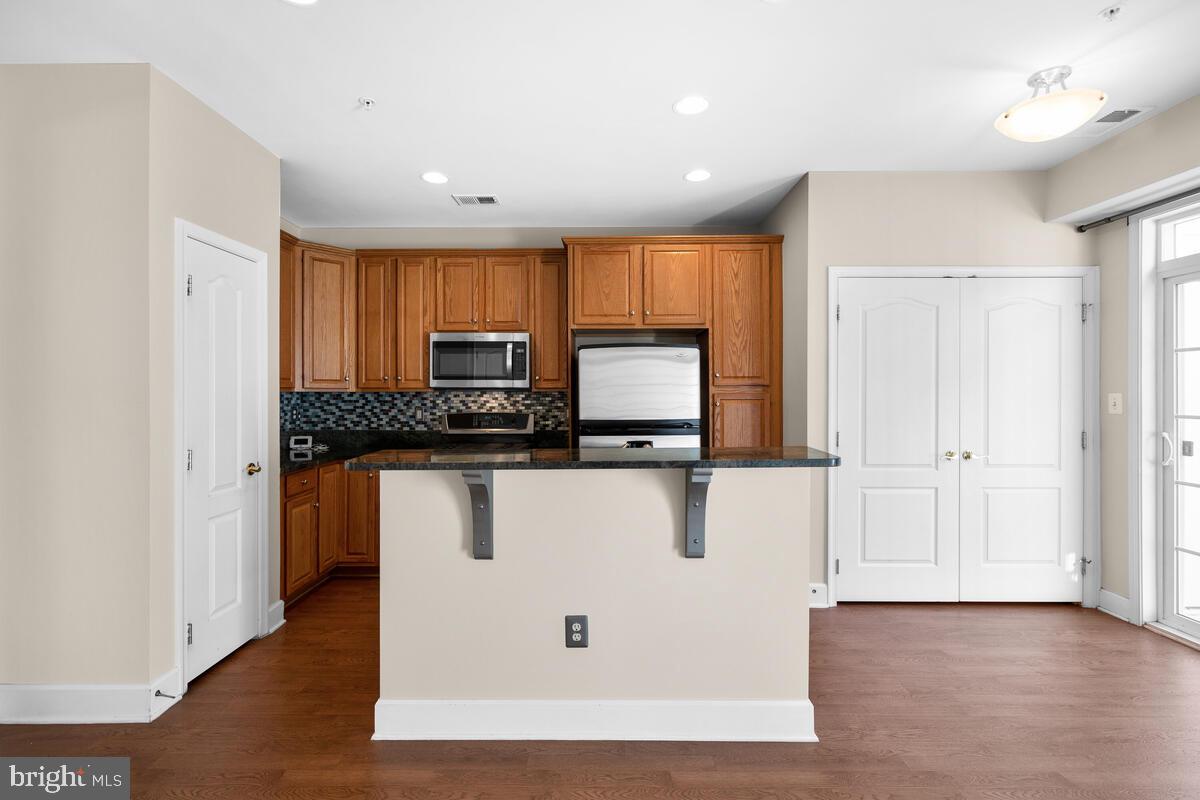13626 Dover Cliffs Place Germantown, MD 20874 - Photo 9 of 32 a view of kitchen with wooden floor