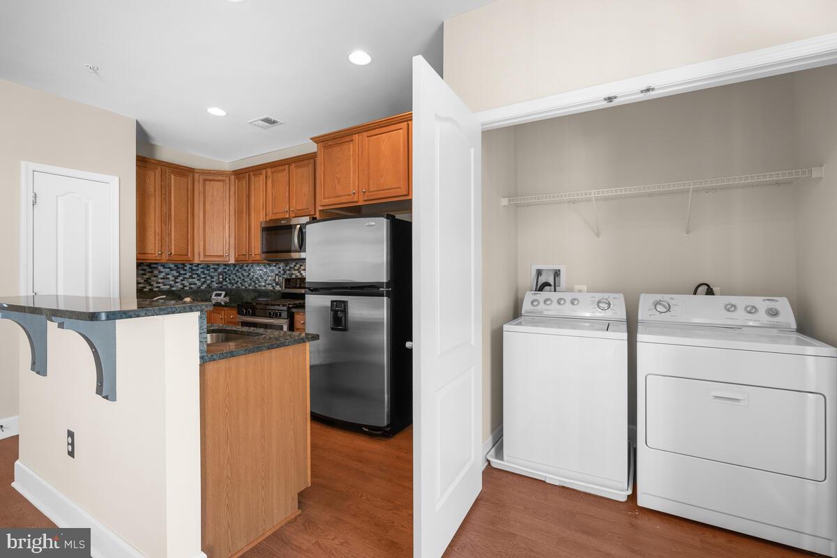 13626 Dover Cliffs Place Germantown, MD 20874 - Photo 10 of 32 a kitchen with refrigerator and cabinets