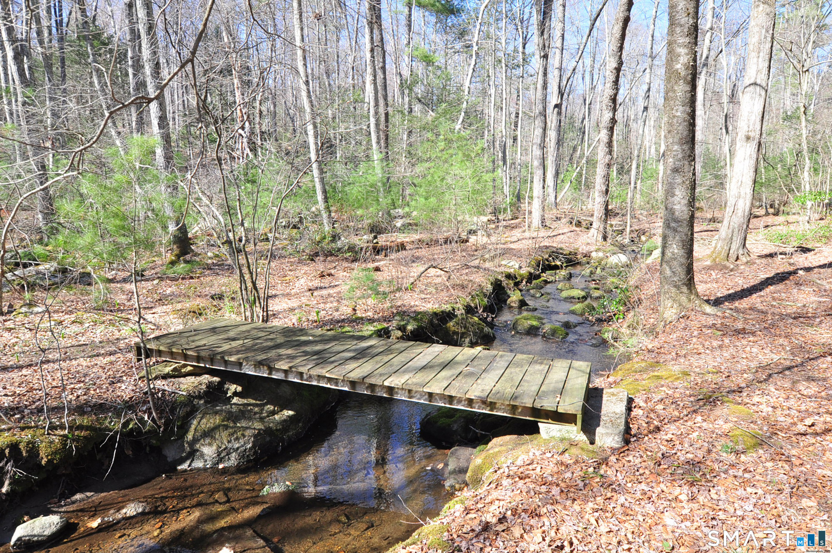82 Indian Hill Road Canton, CT 06019 - Photo 34 of 41 Bridge is located in the rear of the yard that reaches back to the Mary Conklin Sanctuary Trails
