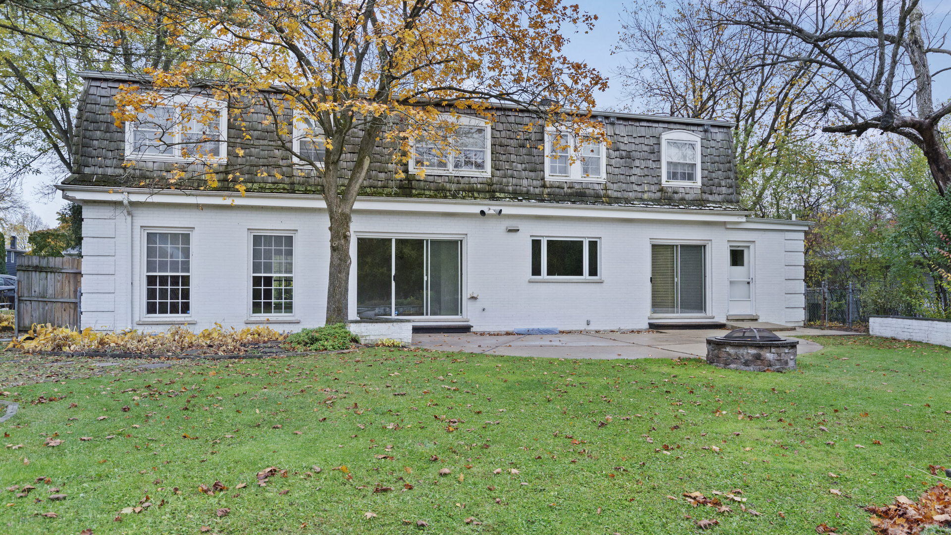 2091 Old Briar Road Highland Park, IL 60035 - Photo 14 of 19 a front view of a house with a garden and trees