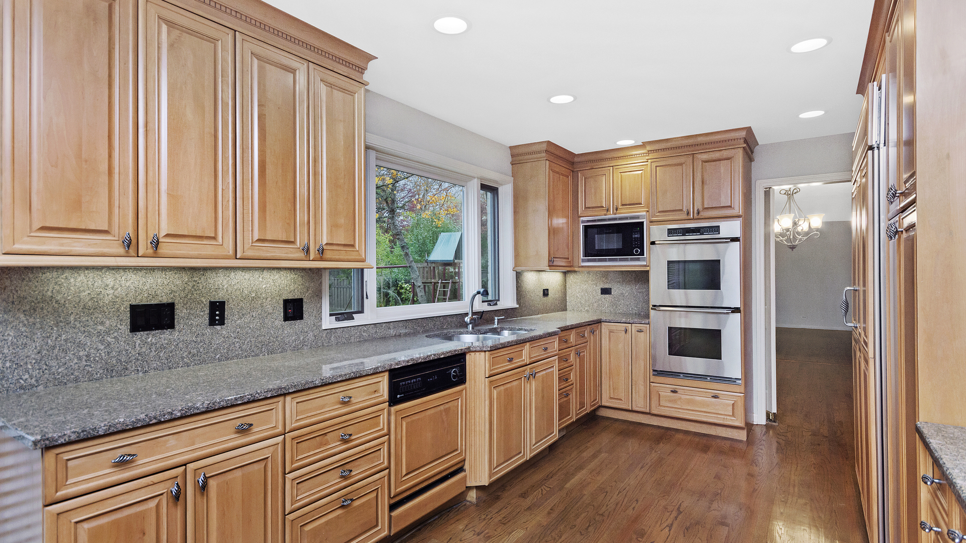 2091 Old Briar Road Highland Park, IL 60035 - Photo 5 of 19 a kitchen with stainless steel appliances white cabinets and wooden floors
