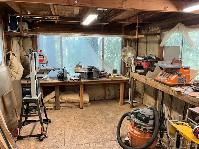 a room with stainless steel appliances kitchen island granite countertop furniture and a wooden floor