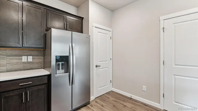 a kitchen with a refrigerator and a sink