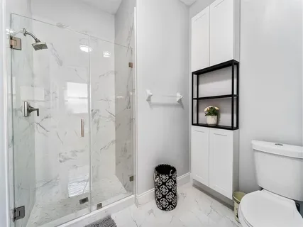 a bathroom with a toilet sink and shower
