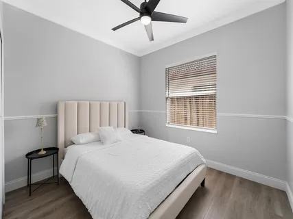 a bedroom with a bed and window