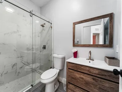 a bathroom with a toilet sink and shower