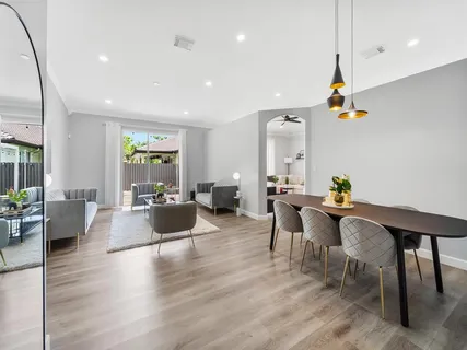 a living room with furniture wooden floor and a table