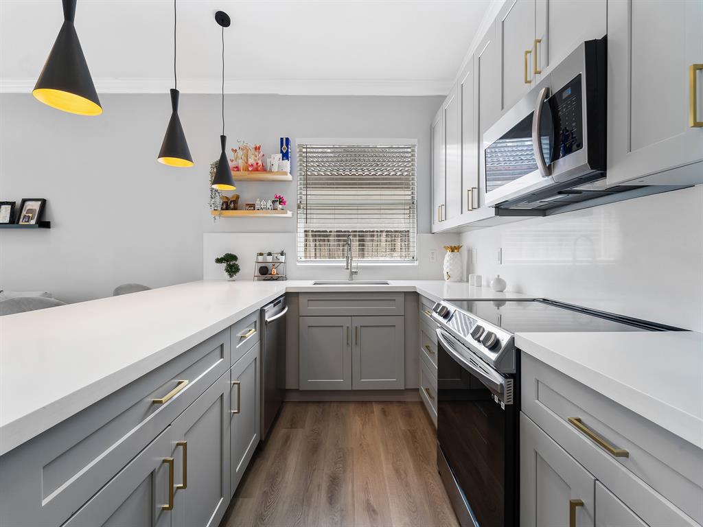 14815 Southwest 28 Lane Miami, FL 33185 - Photo 9 of 19 a kitchen with a sink a stove and cabinets