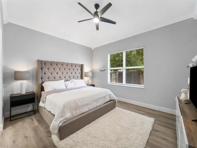 a bedroom with a large bed and a window
