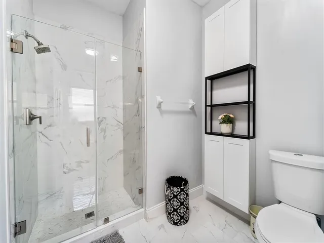 a bathroom with a toilet sink and shower