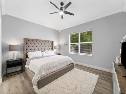 a bedroom with a large bed and a window