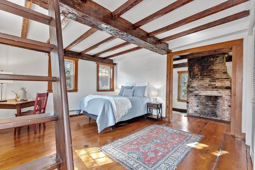 291 Still River Road Harvard, MA 01451 - Photo 21 of 42 a bedroom with a bed a mirror and a rug