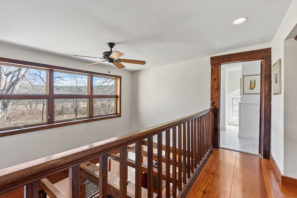 291 Still River Road Harvard, MA 01451 - Photo 25 of 42 a view of a hallway with wooden floor and a ceiling fan