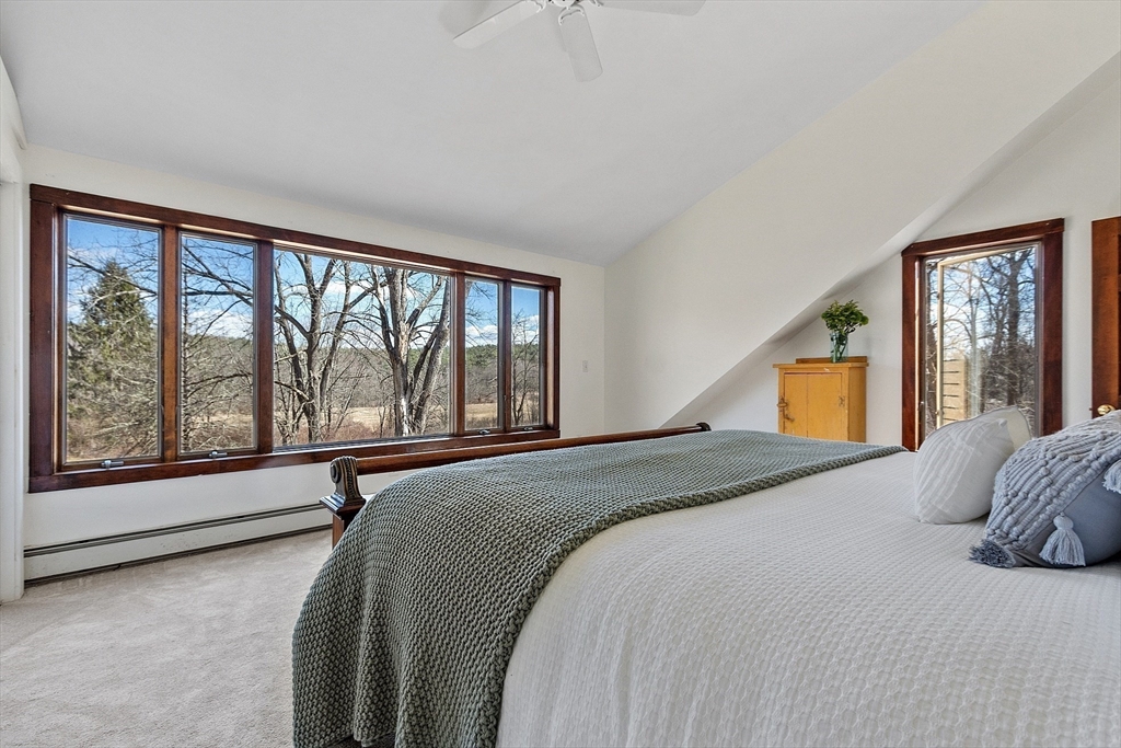 291 Still River Road Harvard, MA 01451 - Photo 33 of 42 a bedroom with a large bed and a large window