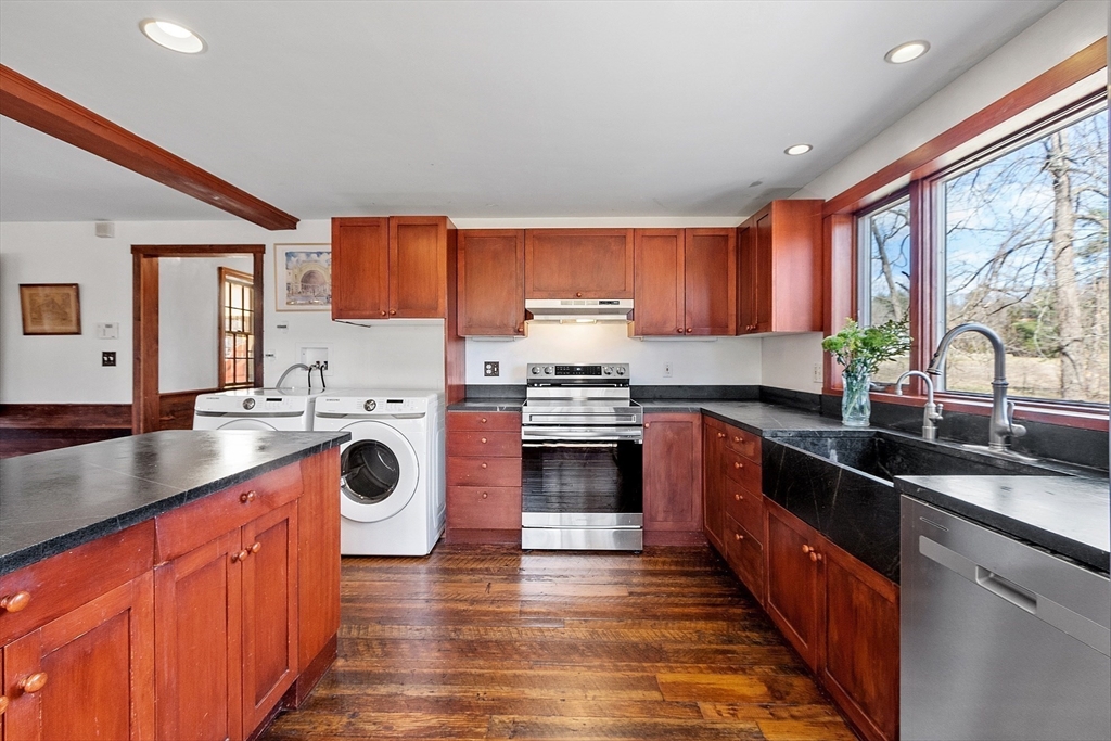 291 Still River Road Harvard, MA 01451 - Photo 10 of 42 a kitchen with stainless steel appliances granite countertop wooden cabinets a sink and a stove