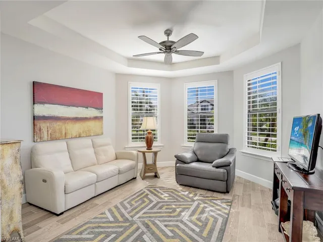 a spacious bedroom with a bed and wooden floor