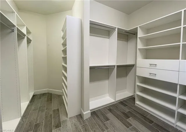 a bathroom with a sink a toilet a mirror and shower