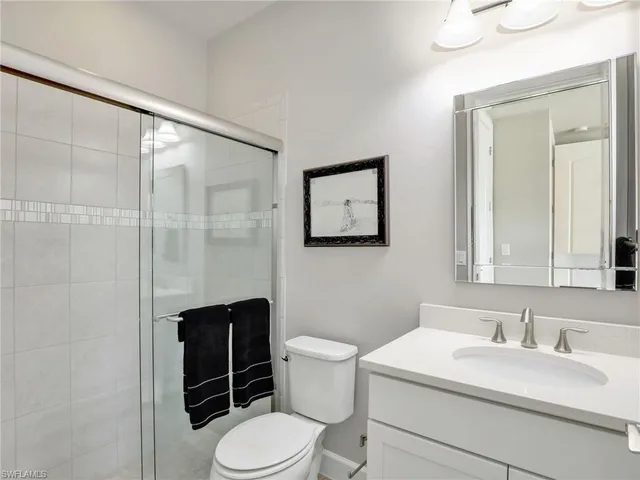 a bedroom with a bed and a lamp