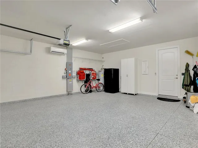 a kitchen with white cabinets and appliances