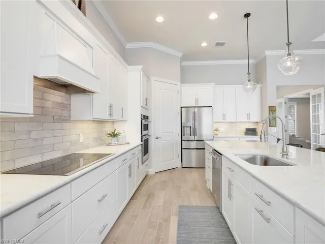 a living room with furniture kitchen view and a large window