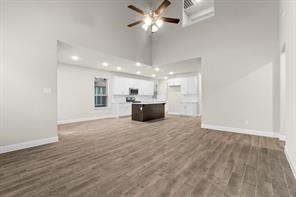 2808 Inn Kitchen Way McKinney, TX 75071 - Photo 5 of 22 Kitchen featuring a central island with a light-toned countertop, white cabinetry, wood-finish flooring, recessed lighting, and a stainless steel appliance suite