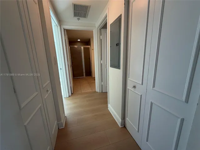 a view of empty room with wooden floor