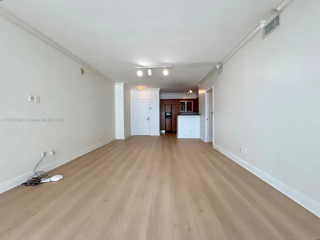 a kitchen with stainless steel appliances granite countertop refrigerator sink and microwave