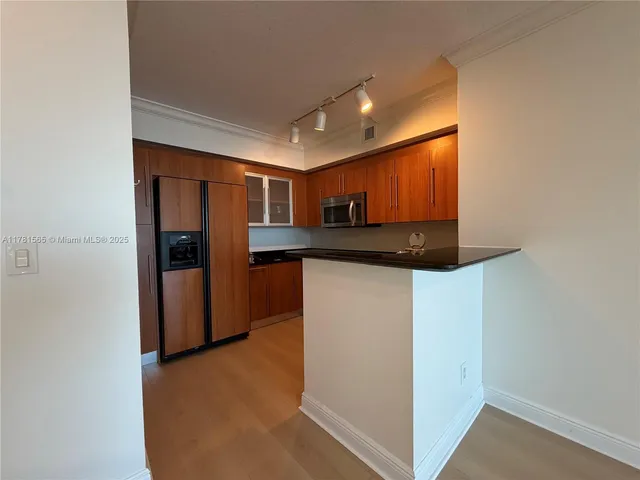a bathroom with a granite countertop sink mirror toilet and bathtub