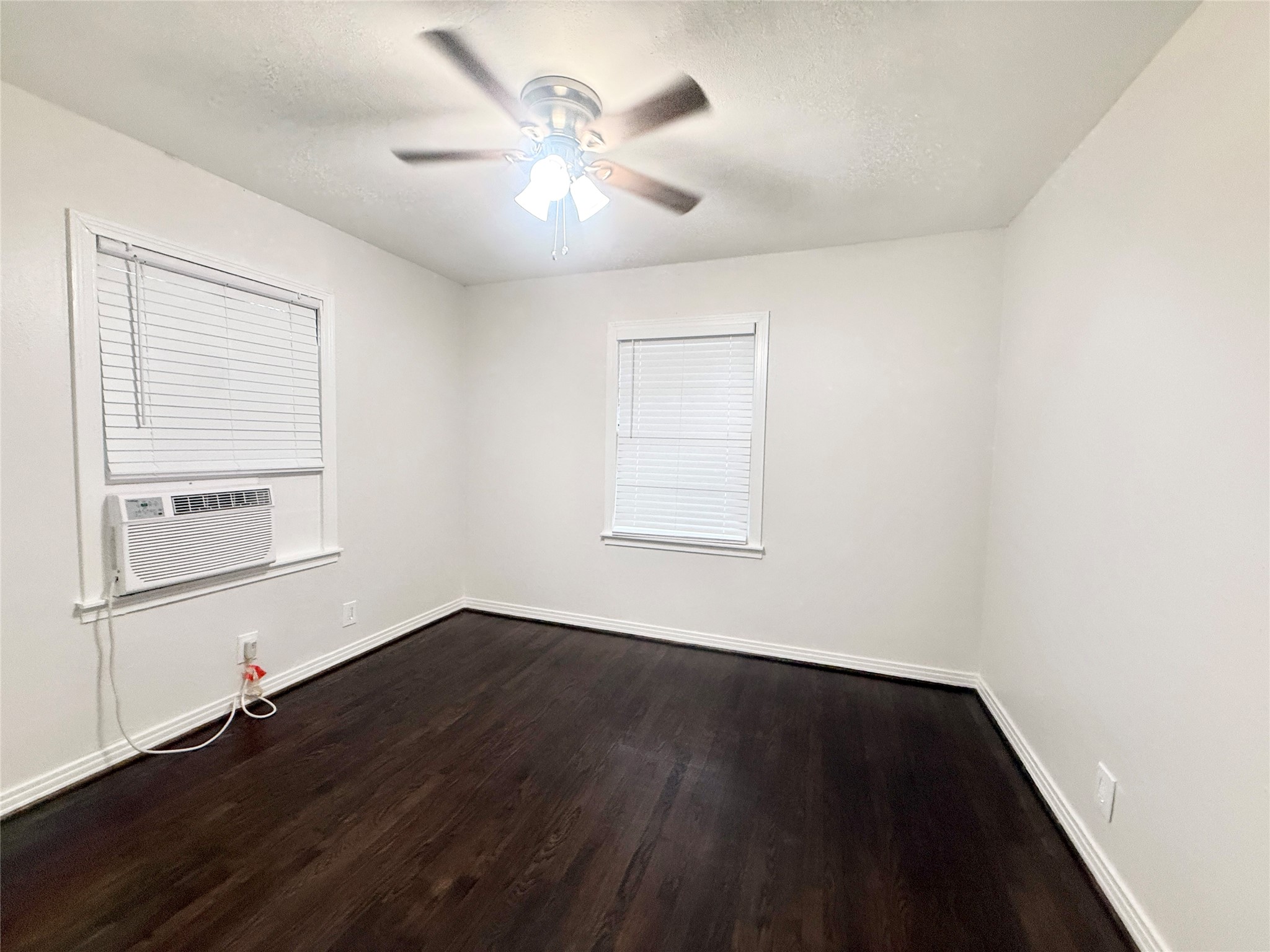 832 South Anderson Street Angleton, TX 77515 - Photo 15 of 19 an empty room with wooden floor and windows