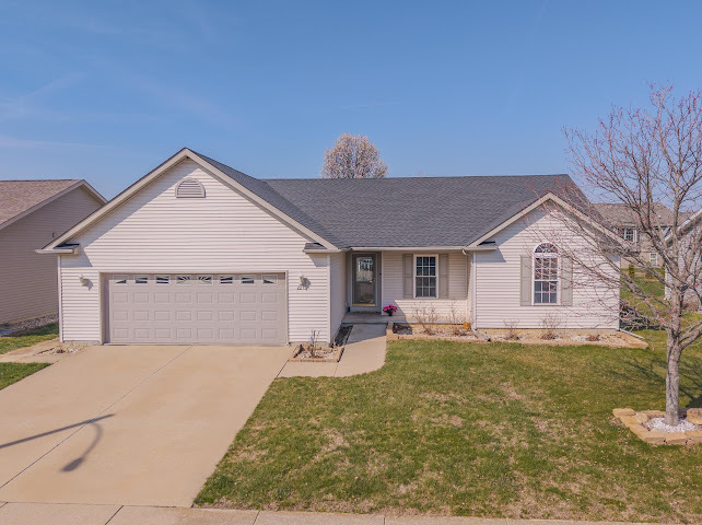 2275 Boulder Drive Normal, IL 61761 - Photo 1 of 41 a front view of a house with a yard and garage