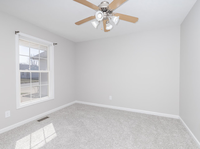 2275 Boulder Drive Normal, IL 61761 - Photo 14 of 41 an empty room with windows and fan