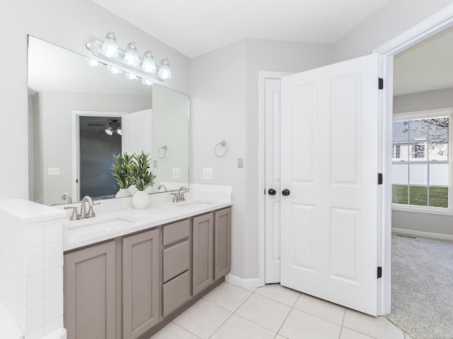 2275 Boulder Drive Normal, IL 61761 - Photo 24 of 41 a bathroom with a double vanity sink and mirror