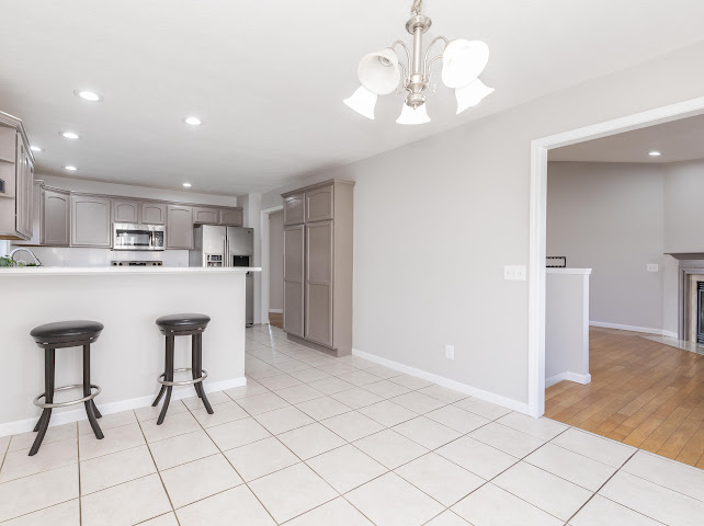 2275 Boulder Drive Normal, IL 61761 - Photo 9 of 41 a kitchen with stainless steel appliances a table and chairs in it