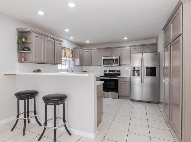 2275 Boulder Drive Normal, IL 61761 - Photo 10 of 41 a kitchen with granite countertop a refrigerator and a stove top oven