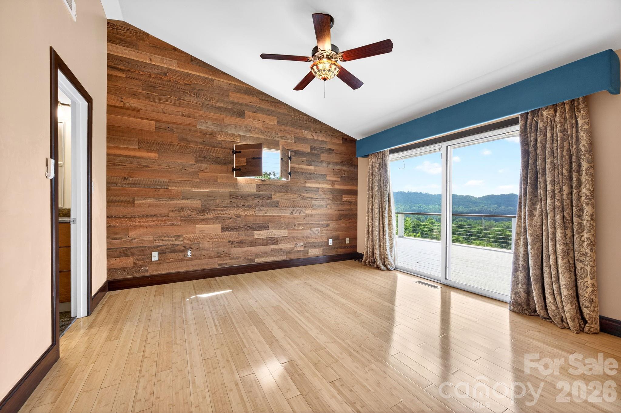 38 Lookout Road Asheville, NC 28804 - Photo 19 of 34 a view of empty room with wooden floor and fan