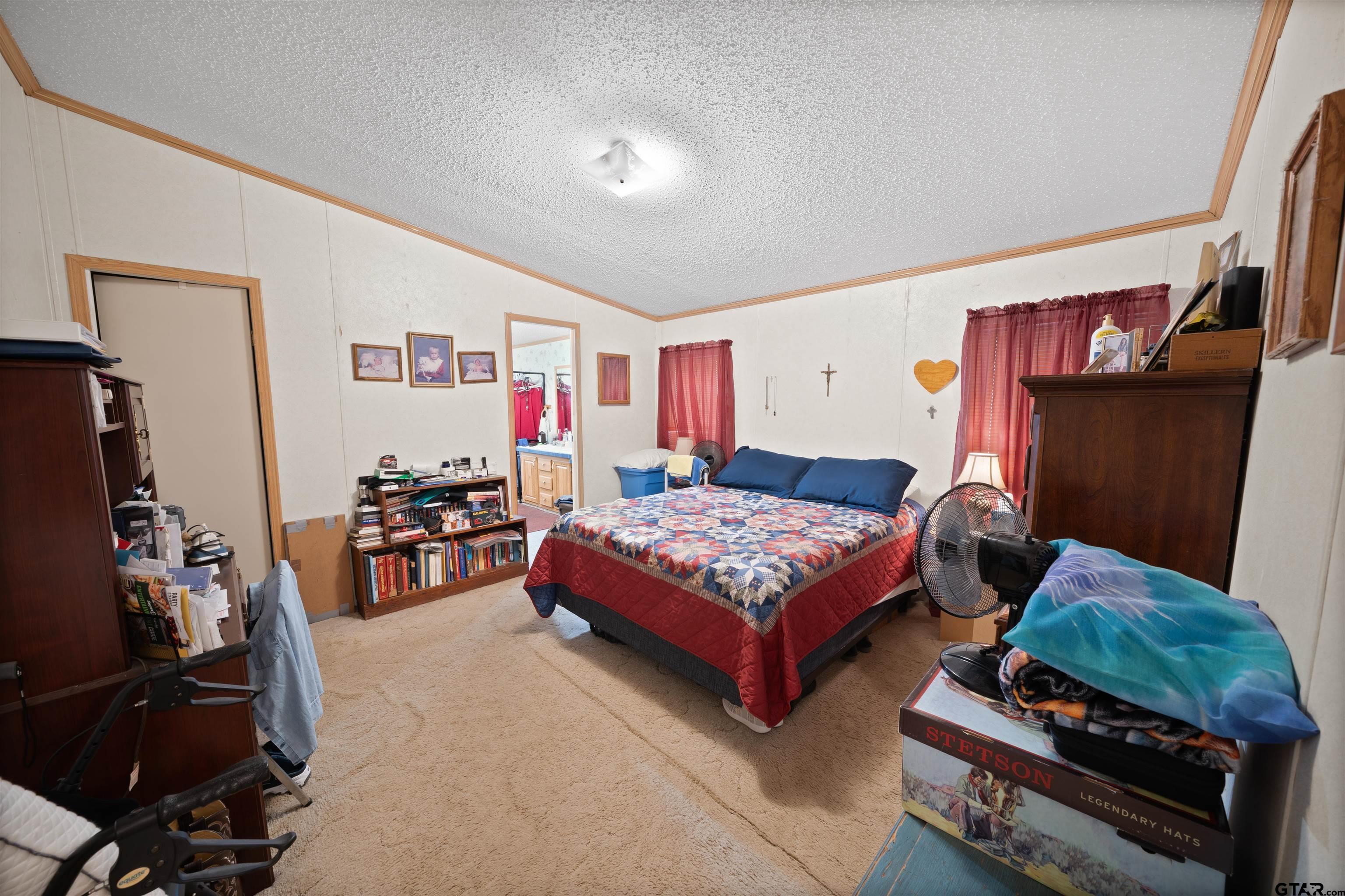 2425 Thompson Lane Tyler, TX 75704 - Photo 19 of 27 a bedroom with bed and a window