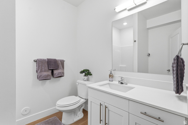 2085 North Main Street, Unit 107 Sunset, UT 84015 - Photo 11 of 21 Full bathroom with vanity, light wood-type flooring, and a shower