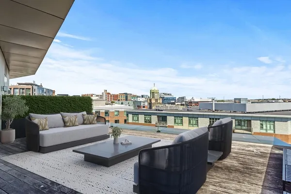 a view of a terrace with couches and sky view