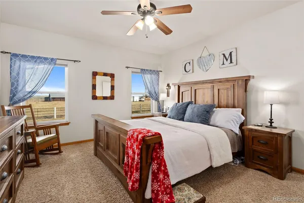 a spacious bedroom with a bed and a chandelier
