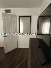 Kendale Lakes Miami, FL 33183 - Photo 14 of 18 a view of a closet area with wooden floor