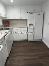 Kendale Lakes Miami, FL 33183 - Photo 7 of 18 a view of a kitchen with an empty space and wooden floor