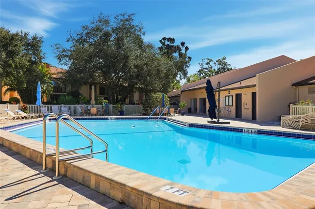 a view of a swimming pool with outdoor seating