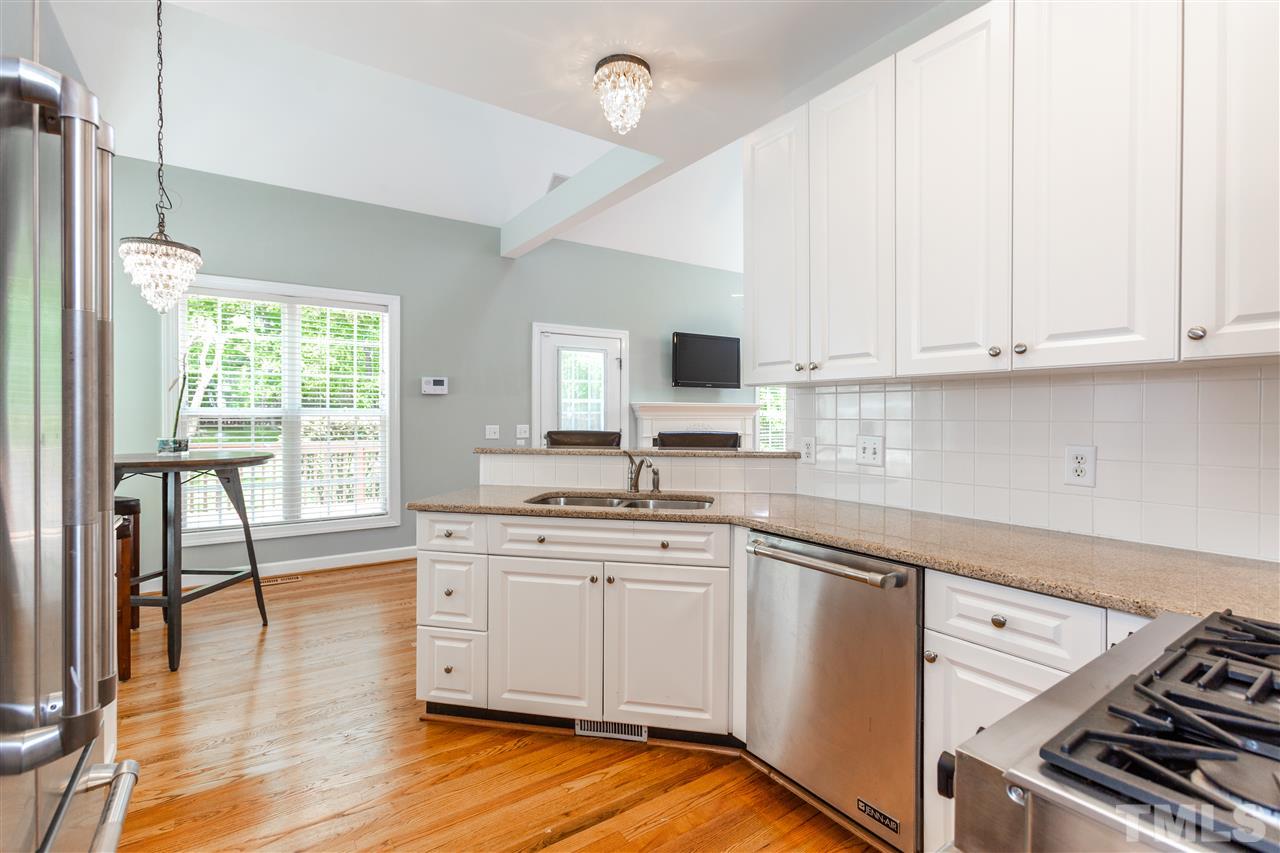 905 Cedar Downs Drive Raleigh, NC 27607 - Photo 3 of 25 a kitchen with a stove a sink and a refrigerator