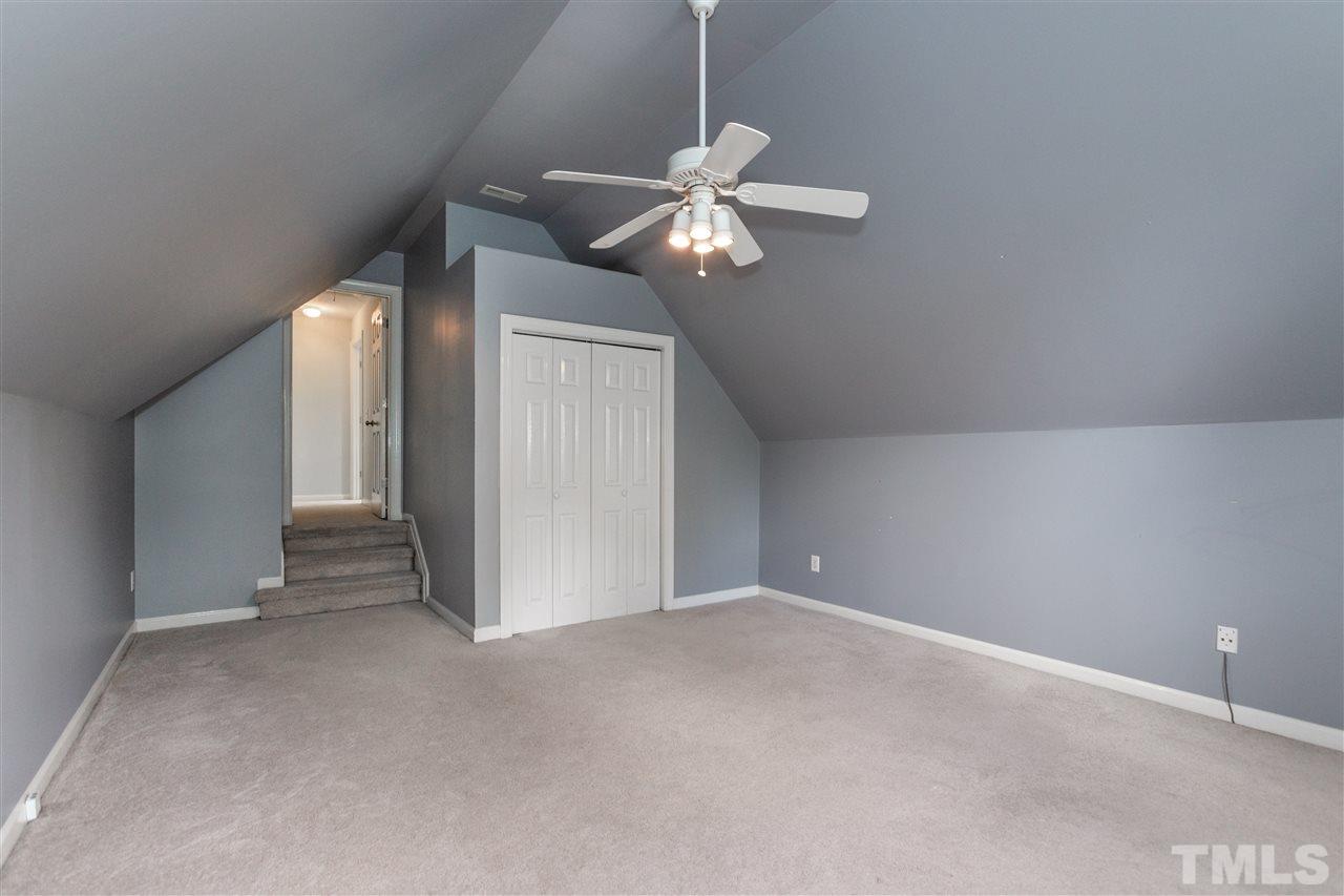 905 Cedar Downs Drive Raleigh, NC 27607 - Photo 22 of 25 a view of an empty room and chandelier fan