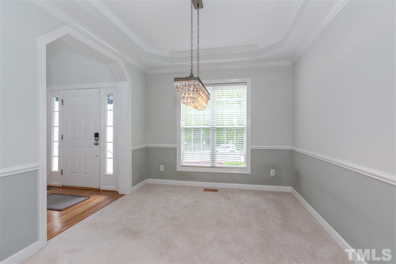 905 Cedar Downs Drive Raleigh, NC 27607 - Photo 8 of 25 a view of an empty room with window and cabinet area
