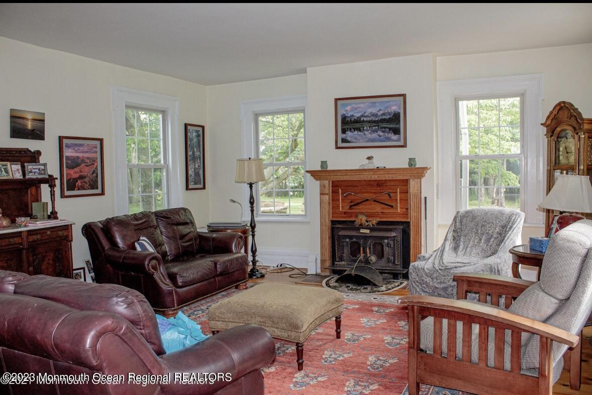415 Pleasant Valley Road Morganville, NJ 07751 - Photo 11 of 16 a living room with furniture and a fireplace