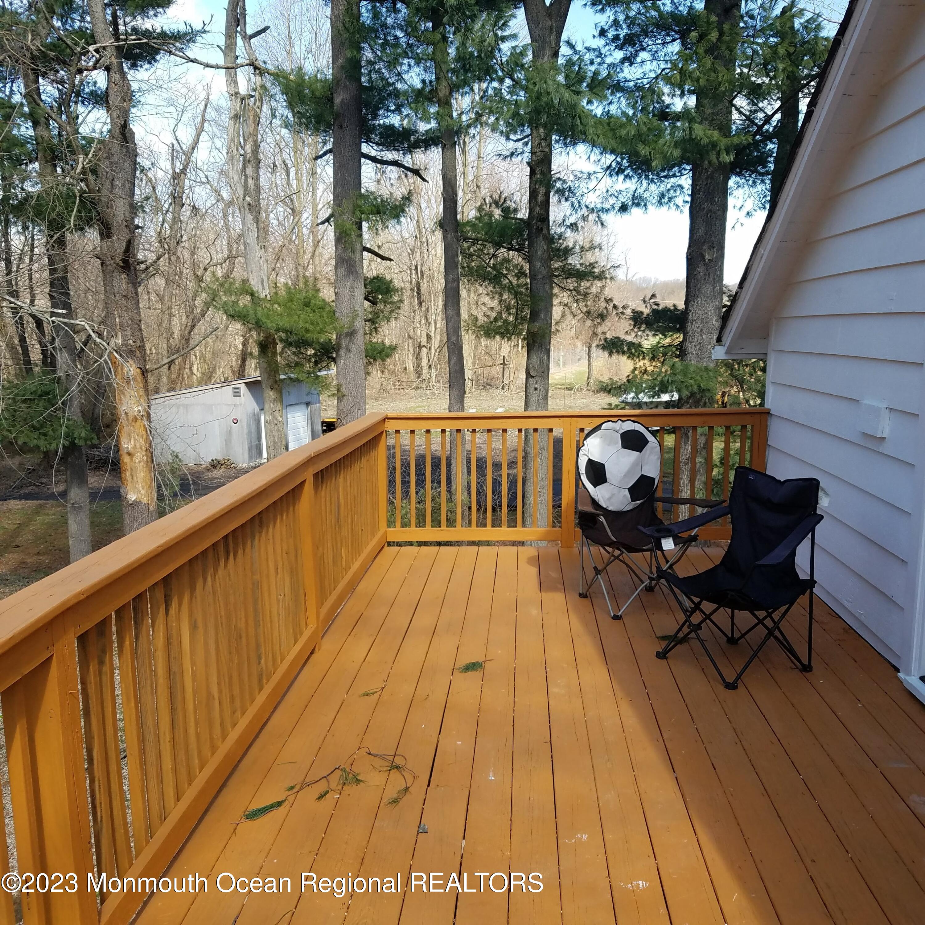 415 Pleasant Valley Road Morganville, NJ 07751 - Photo 13 of 16 a view of balcony with wooden floor and outdoor seating