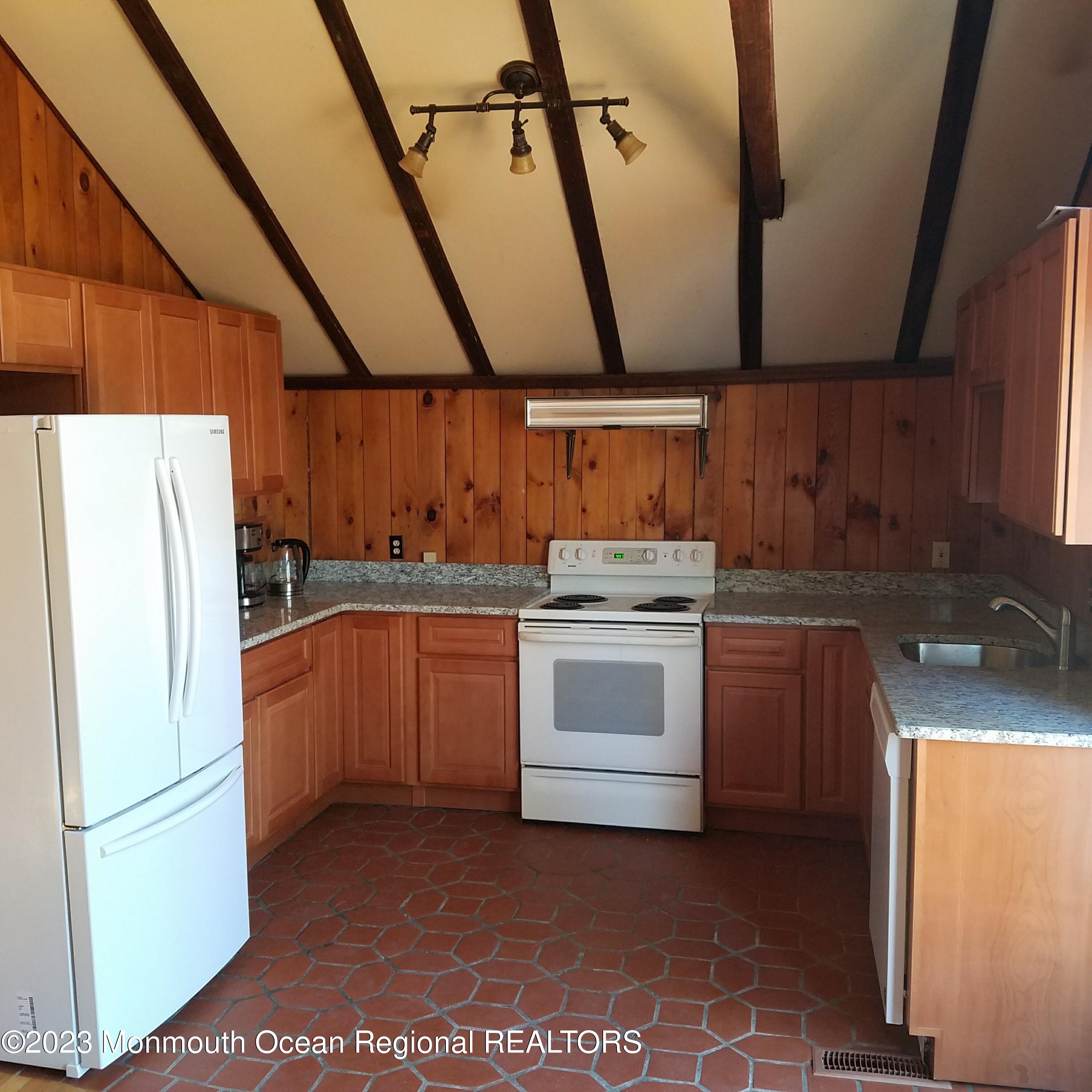 415 Pleasant Valley Road Morganville, NJ 07751 - Photo 16 of 16 a kitchen with a refrigerator sink stove and cabinets